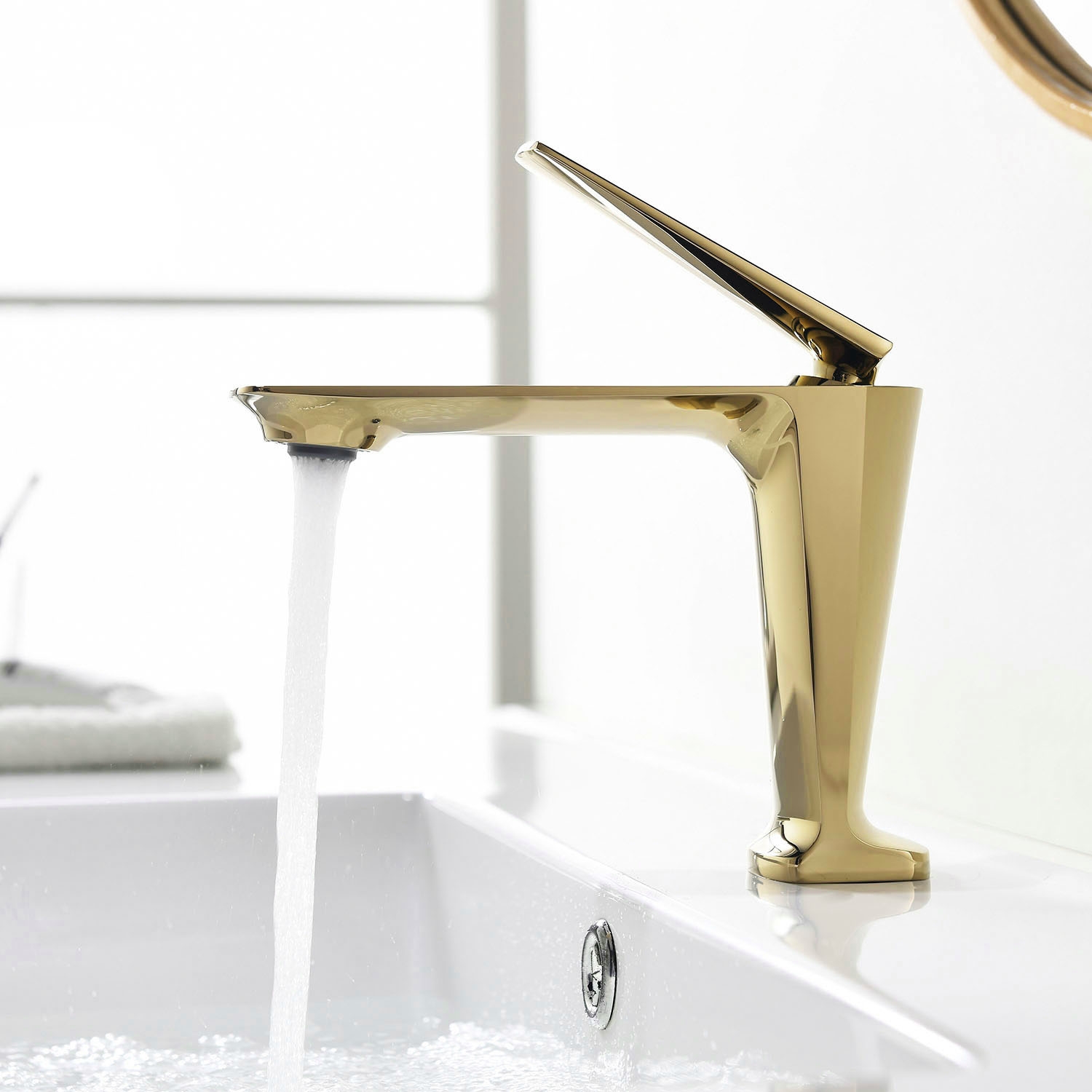 Brushed gold single-hole bathroom faucet showing spout reach and deck-mounted geometry