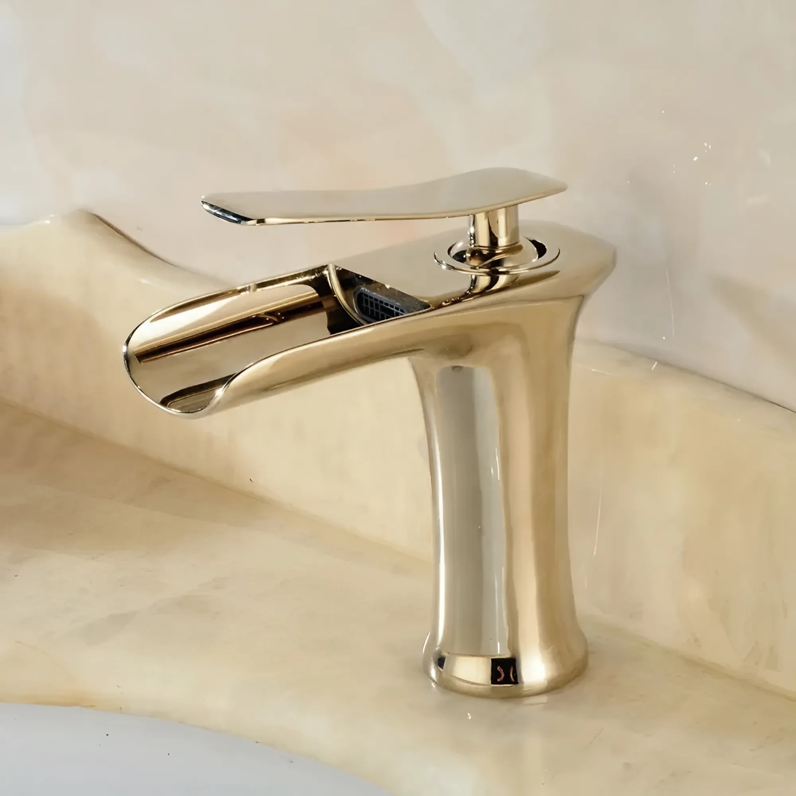 Gold single-hole waterfall basin faucet illustrating warm-metal finish coordination