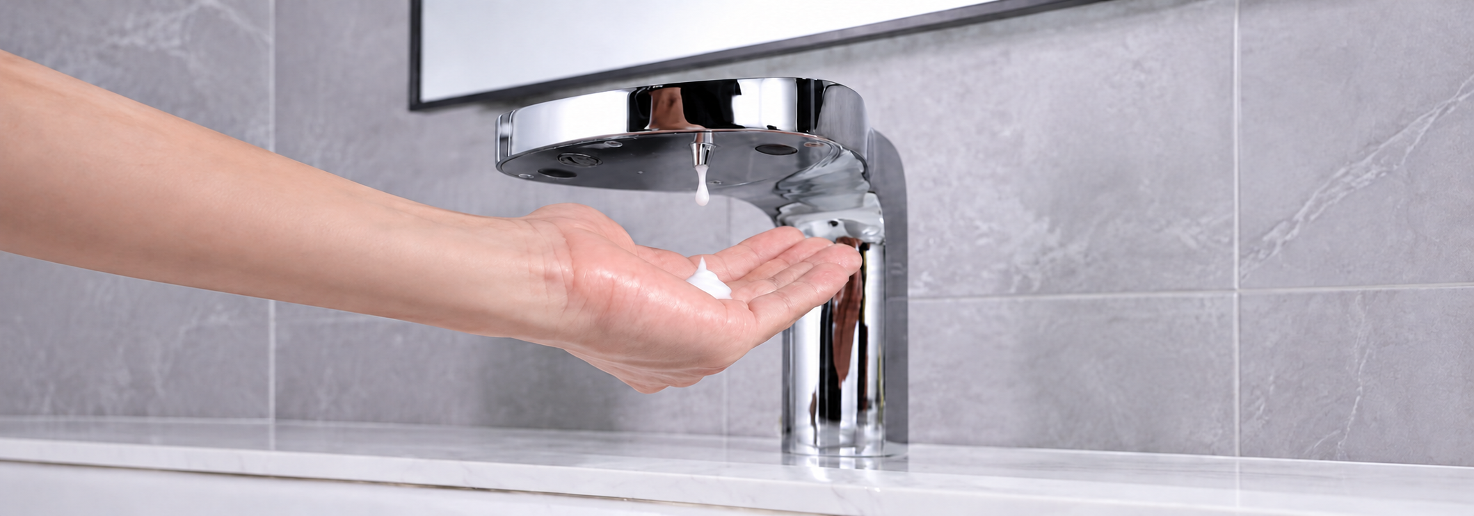 Modern commercial restroom with touchless soap dispenser and automatic fixtures